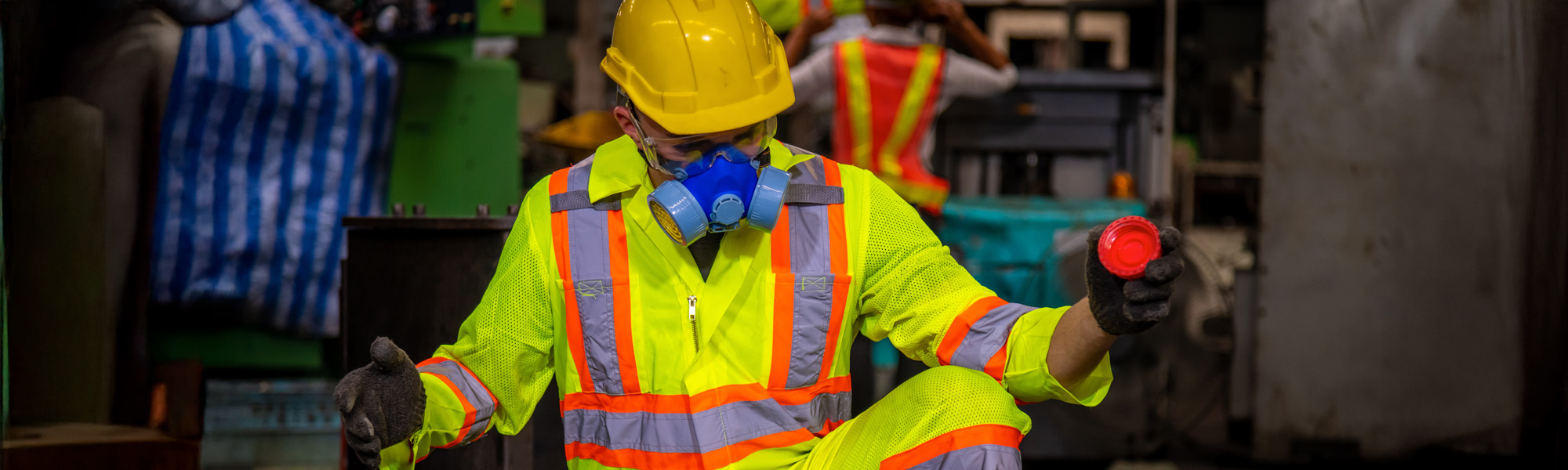 A Engineer industry wearing safety uniform black gloves and gas mask under checking chemical tank