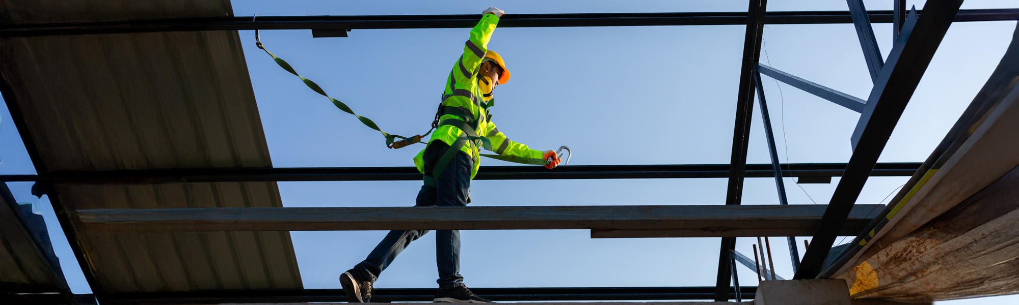 Asian worker wear safety height equipment to install the roof in the construction site