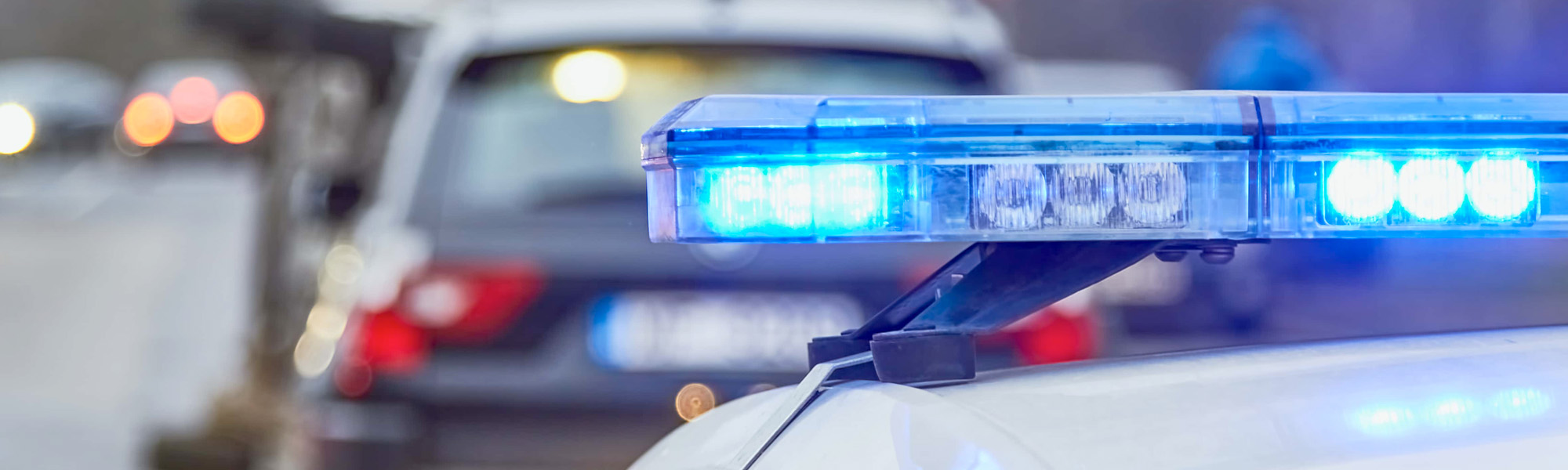 Blue lights of a police car at the scene of an accident