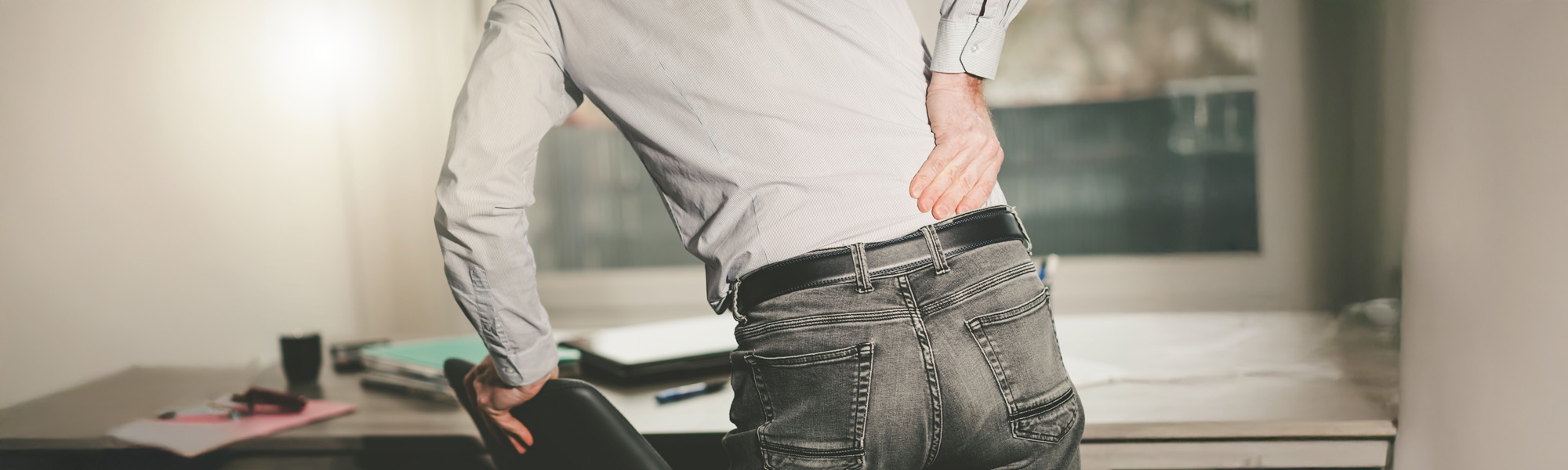 Businessman suffering from back pain light effect