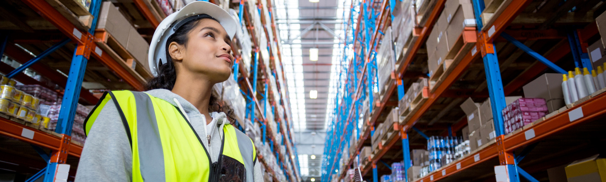Female warehouse worker looking at packages
