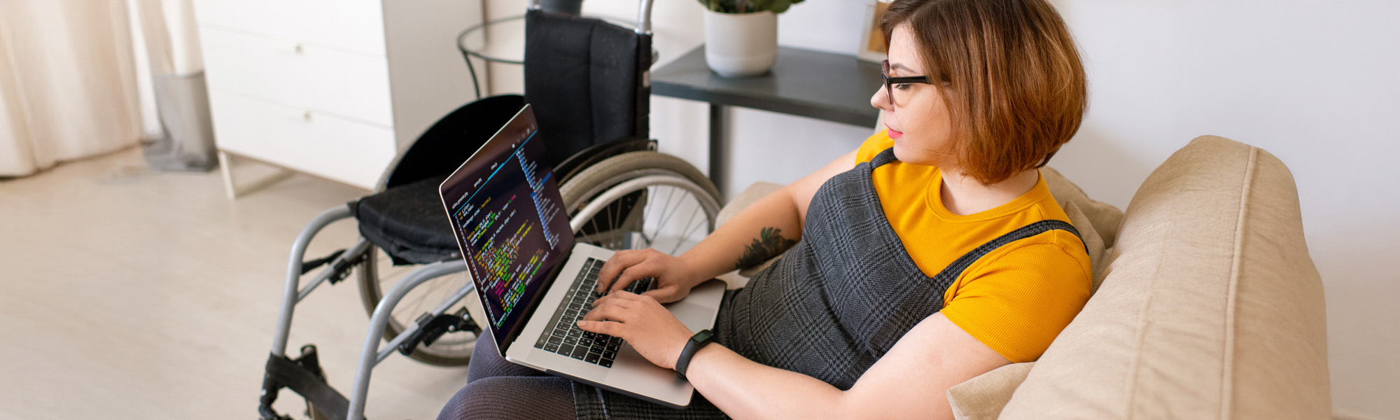 Welcome to our team. Cropped view of young male office worker in a wheelchair shaking hand to his colleague while working together in the creative office Disability concept