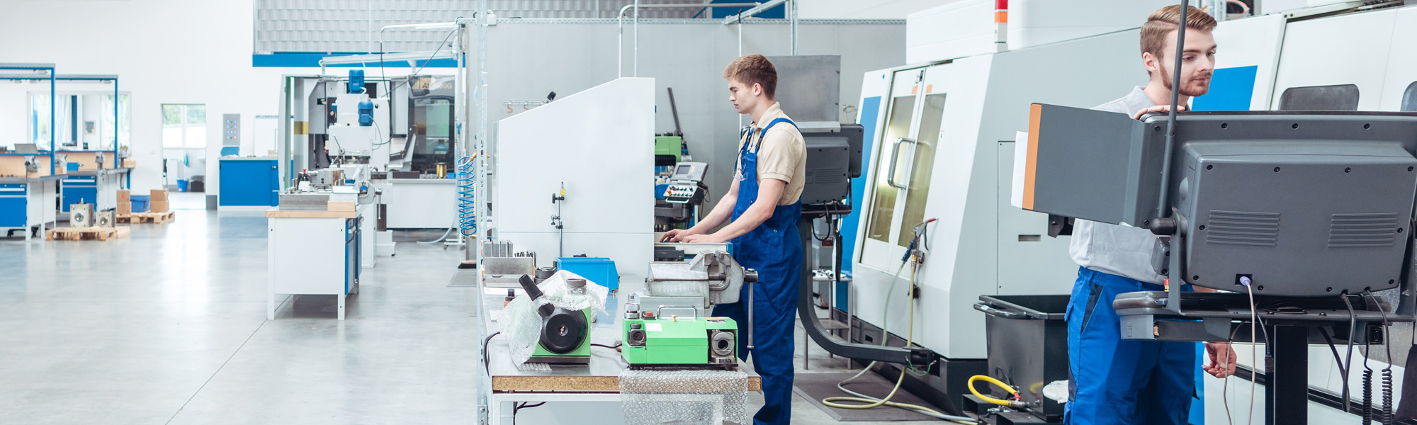 Workers working on the factory floor in well lit hall