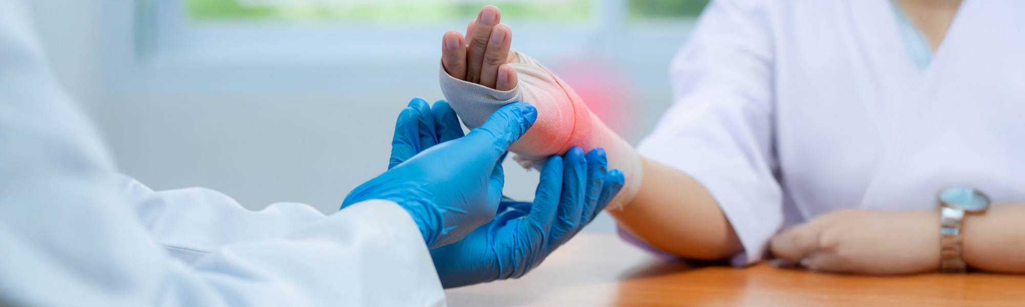 doctor wear medical gloves Of Doctor Hand Tying Bandage On The wrist