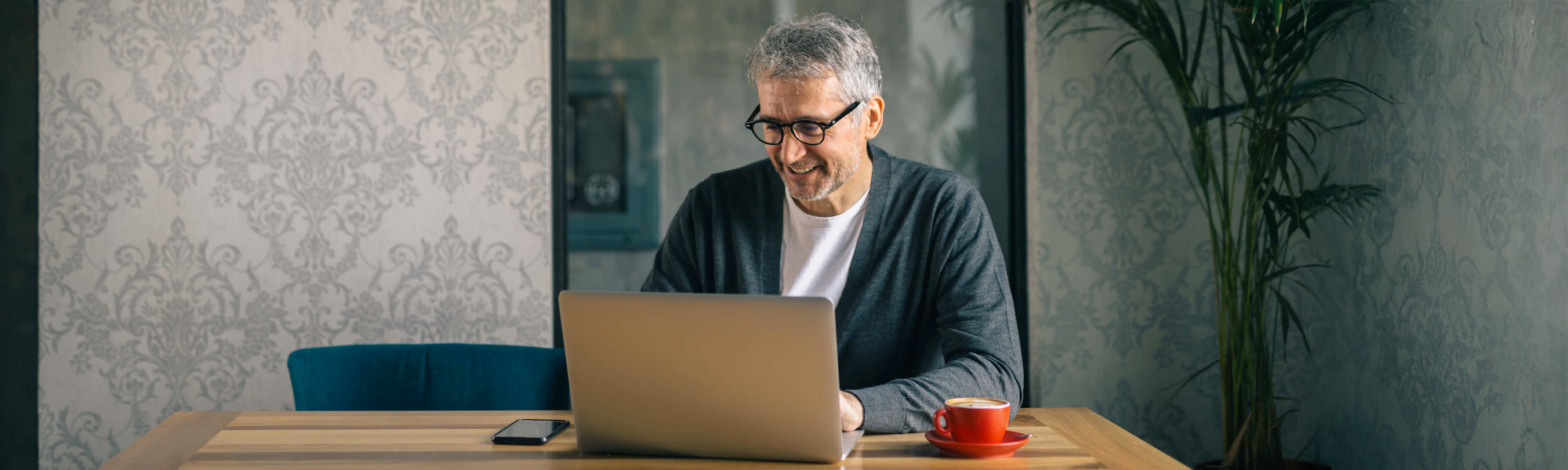 man using laptop in cafe bar