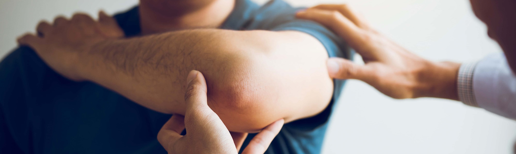 physical therapists are checking patients elbows at the clinic office room