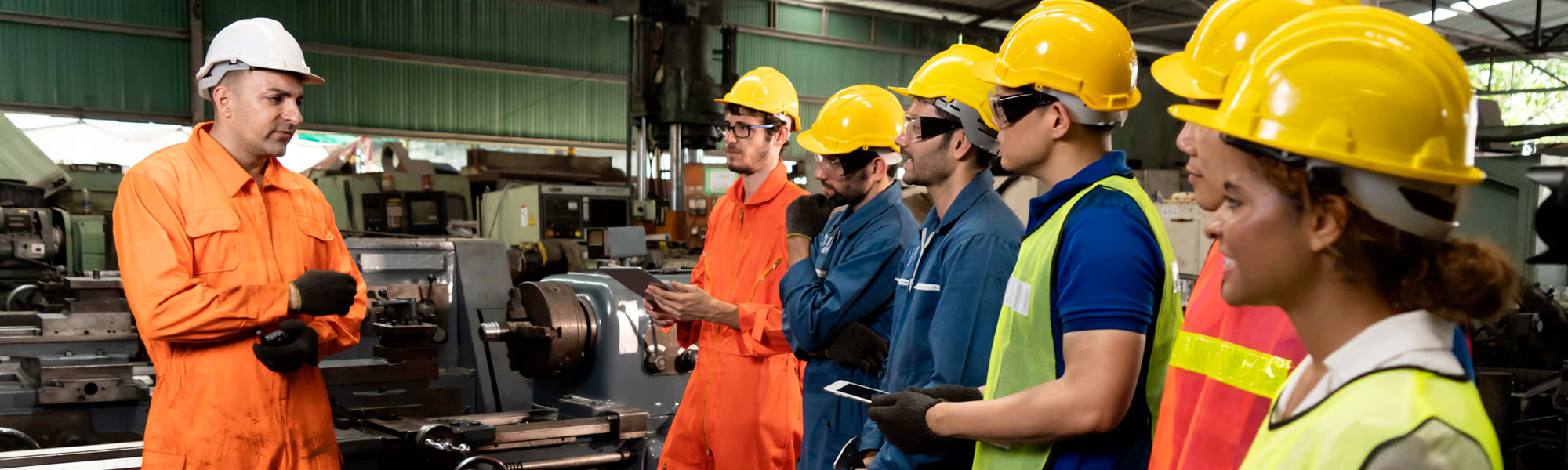 skillful worker attending brief meeting in the factory