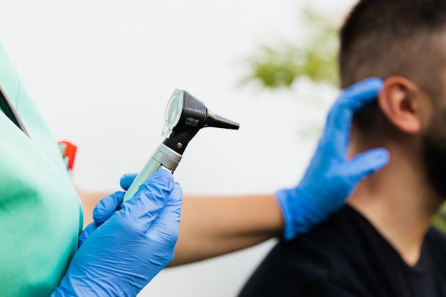 medical provider looking in someone's ear