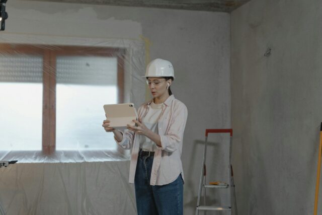 woman standing in front of ladder at work site