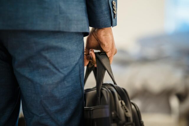man in suit holding briefcase